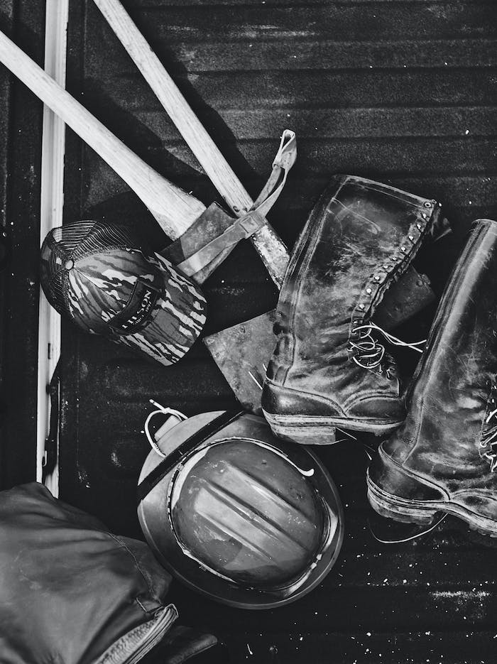 black and white firefighter gear on wood floor