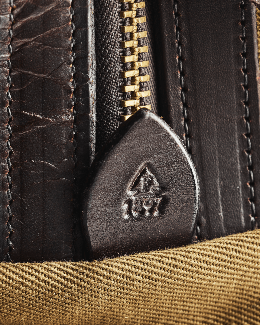 Close up of Filson Rugged Twill bag, showing detail of fabric and Bridle Leather.