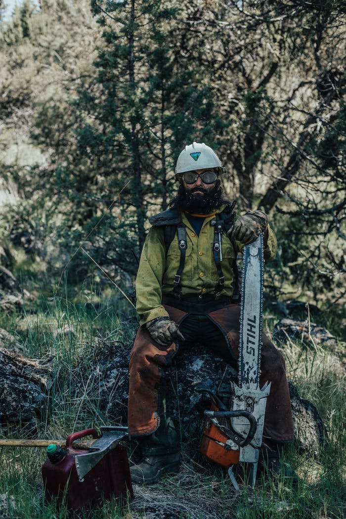 veterans hot shot crew member sitting on rock with chainsaw